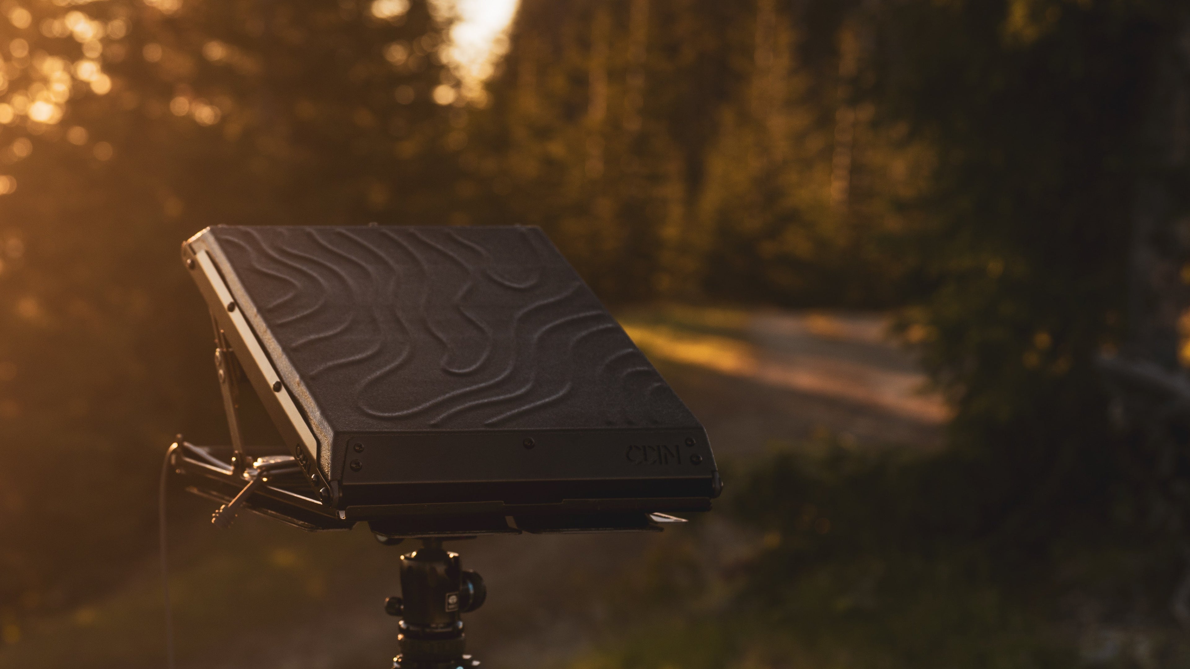 Tuff Mount for Starlink Mini on a tripod in the forest at sunset
