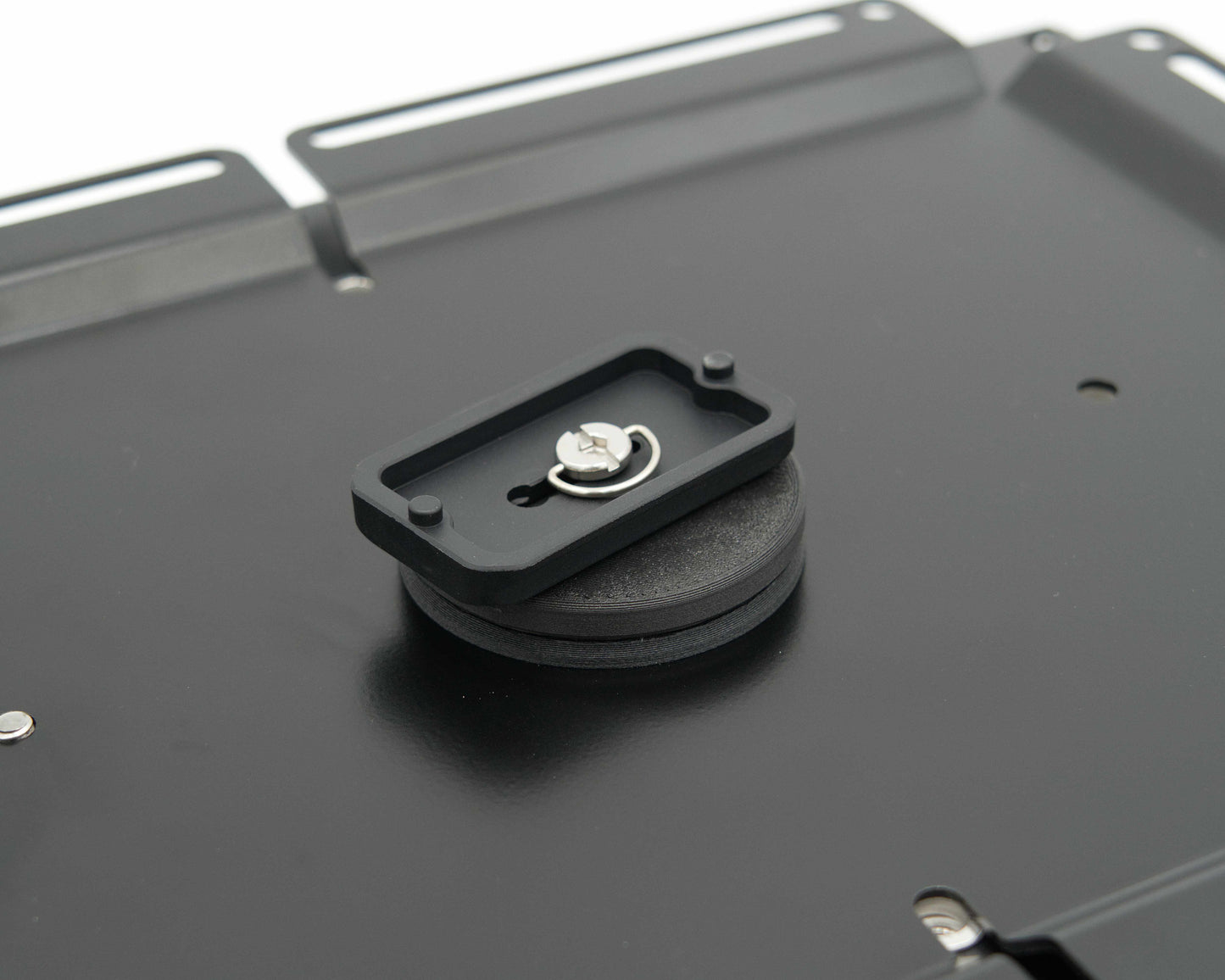 Close-up of the Tuff Mount Tripod Adapter with tripod mount attached to the underside of the Tuff Mount. 